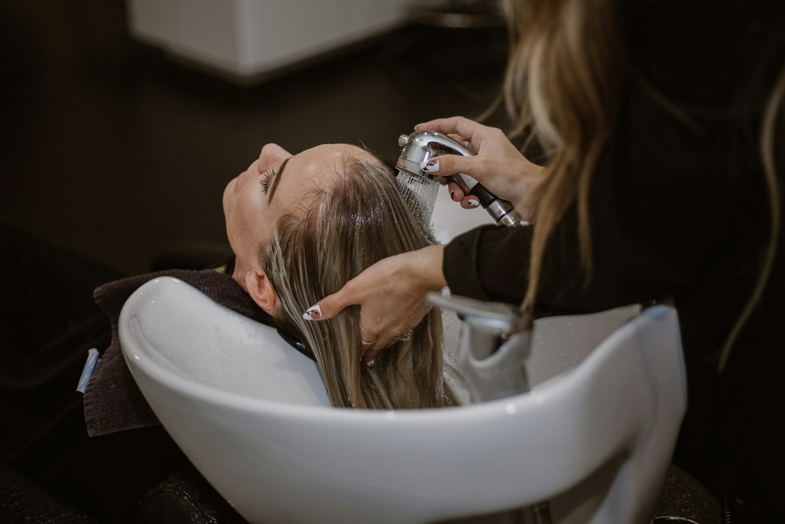 Client getting her hair cut by a stylist