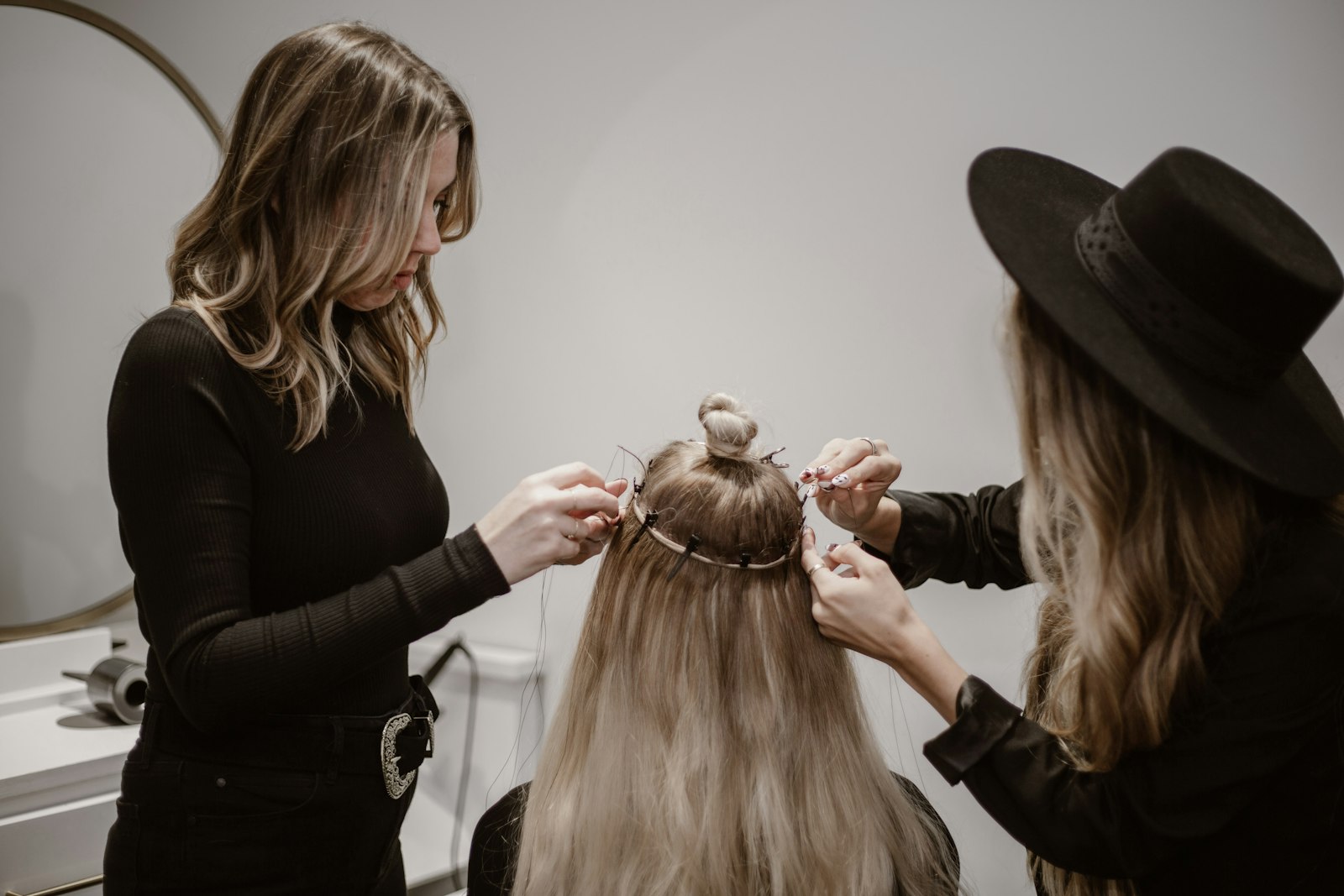 Client getting her hair styled by a hairdresser