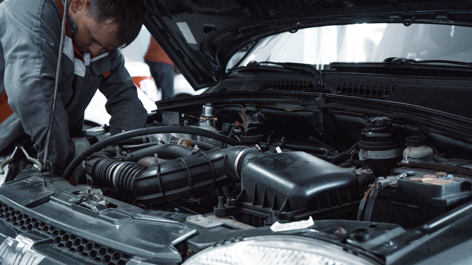 Mechanic standing beside a car
