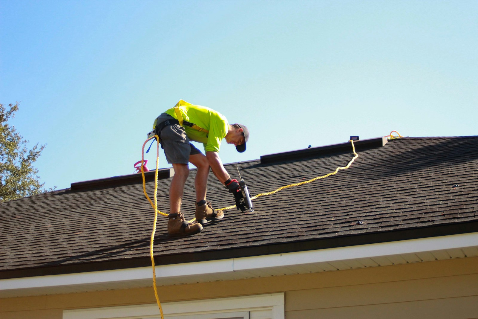 Roofer installing tiles on a residential roof